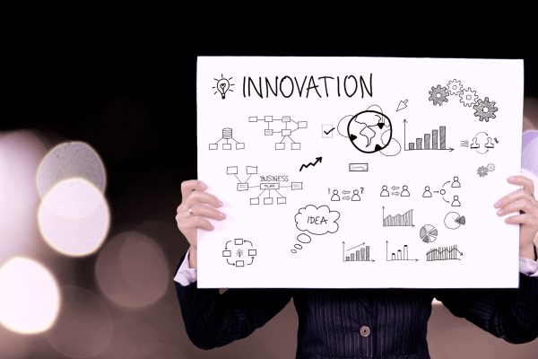 Person Holding Innovation Sign