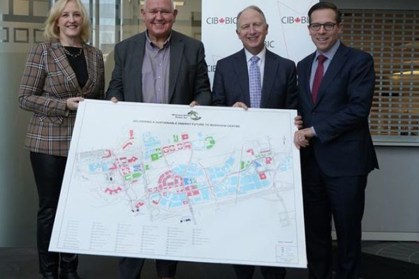 Mayor Scarpitti and MDE staff holding a map.