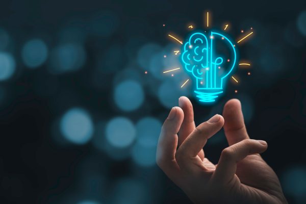 Hand with a light bulb / brain drawing above it.