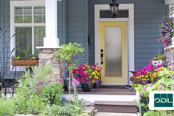 A door on a house with flowers and the ODL logo