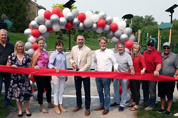 Group of people standing together at a ribbon cutting event
