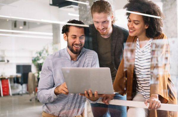 three coworkers looking at a computer
