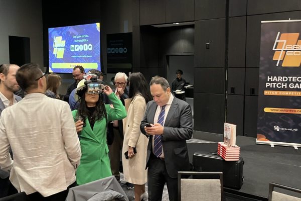 Woman in green testing a VR head set at VentureLab's Hard Tech Summit 2023