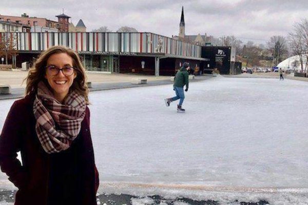 Elizabeth Hawkins in front of Riverwalk Commons
