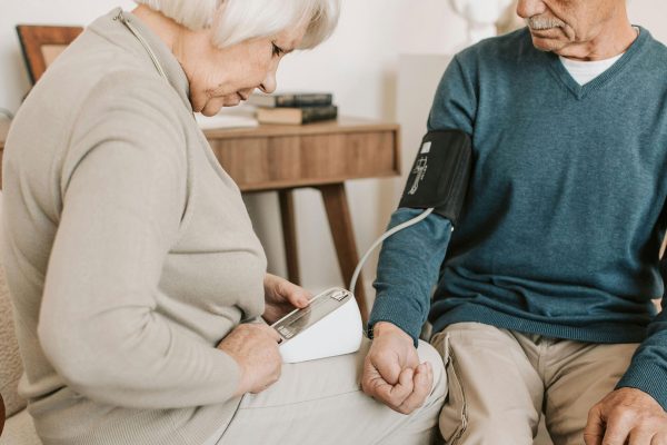 Seniors testing blood pressure