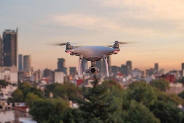 Drone flying with cityscape in background