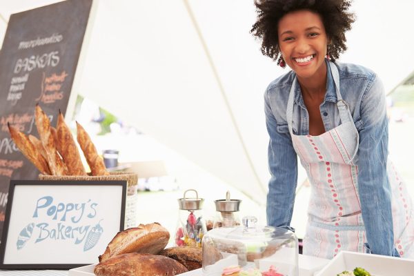 Black entrepreneur selling her products at a marketplace event