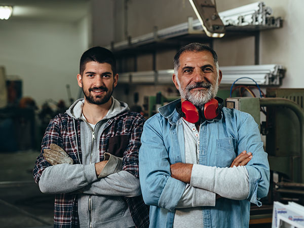 Father and Son posing for a photo at a family run business