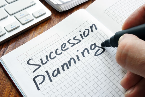 Succession Planning written in a notebook